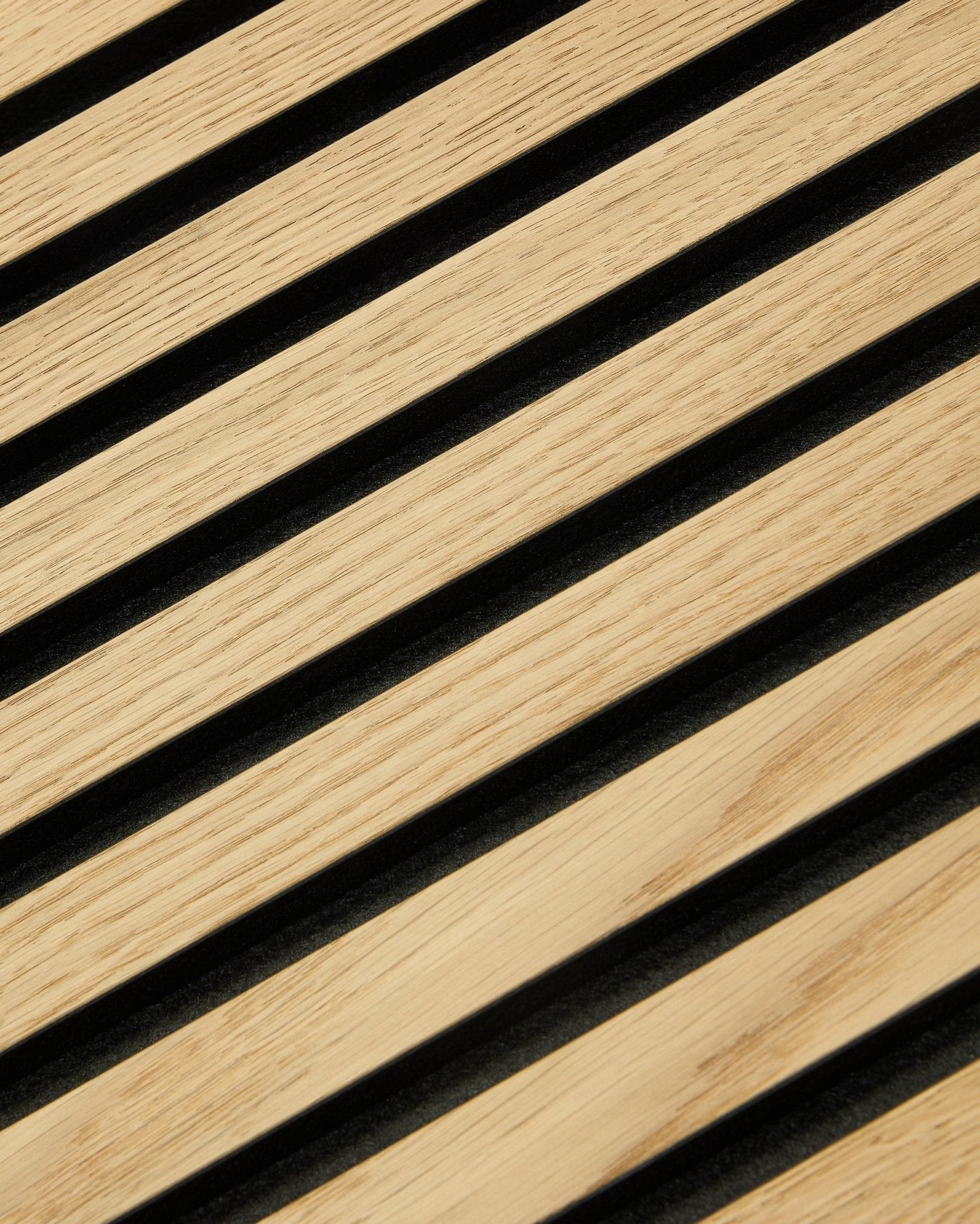 Close-up of WoodUpp Original Akupanel acoustic panel with Classic Oak slats, black felt backing, and MDF, measuring 300x60 cm for modern Nordic interiors.