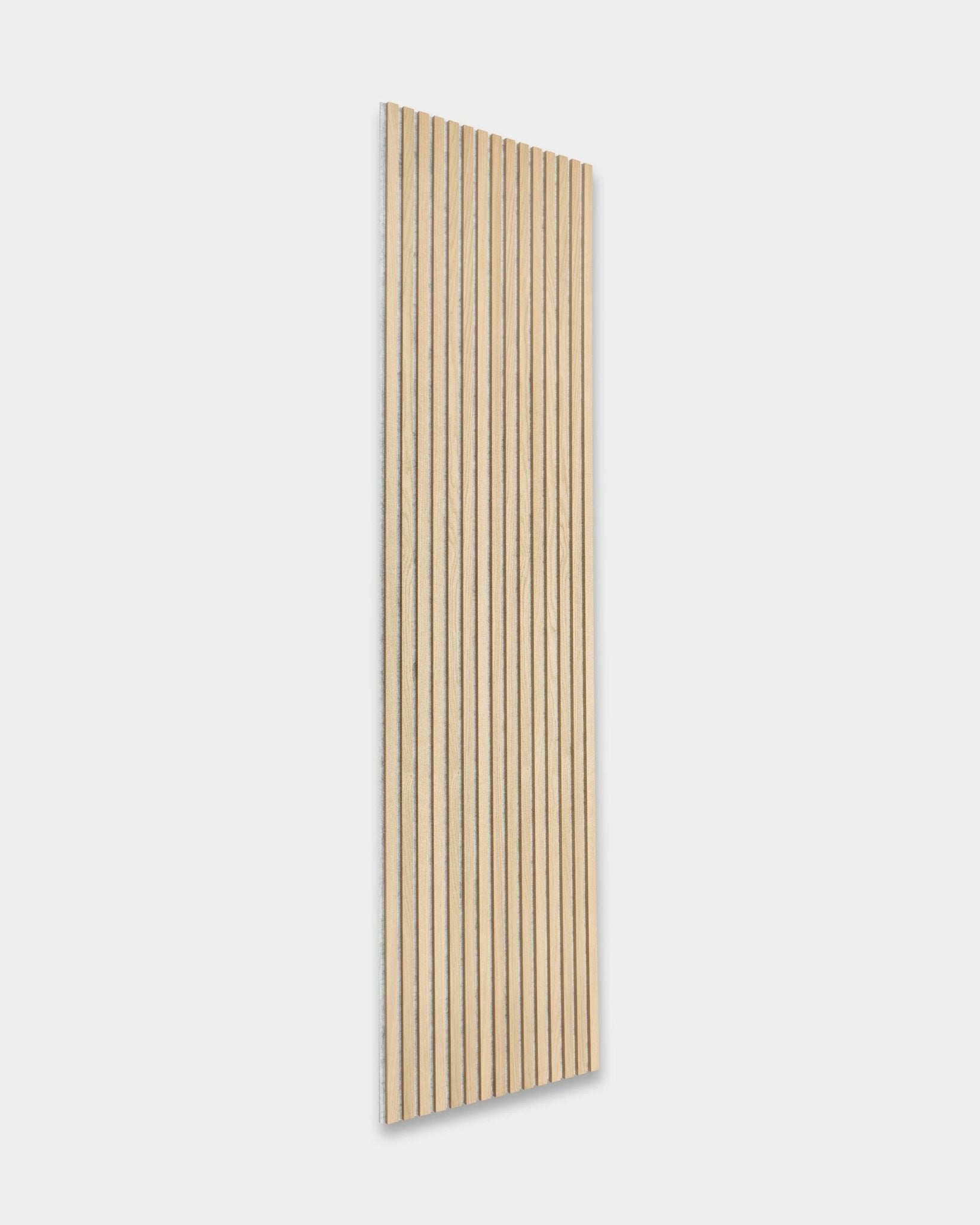 Akupanel acoustic panel by WoodUpp in Classic Oak with grey felt (300x60 cm) provides minimalist Nordic style contrast on light walls.