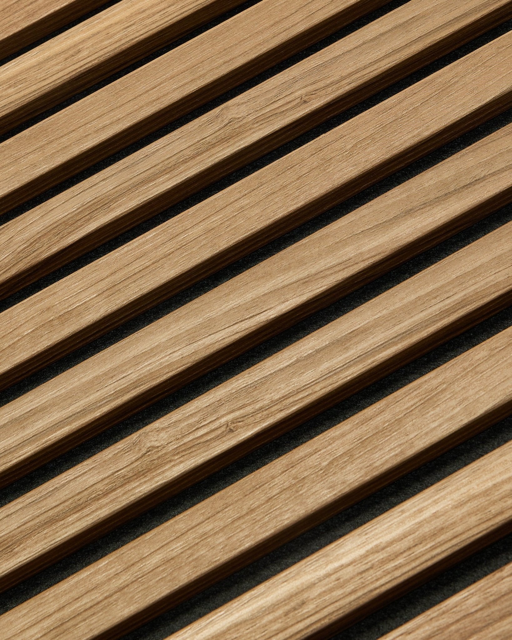 Diagonal close-up of WoodUpp Akupanel Essential acoustic panel in English Walnut, 240x60 cm, showing consistent finish and dark background between each wood slat.
