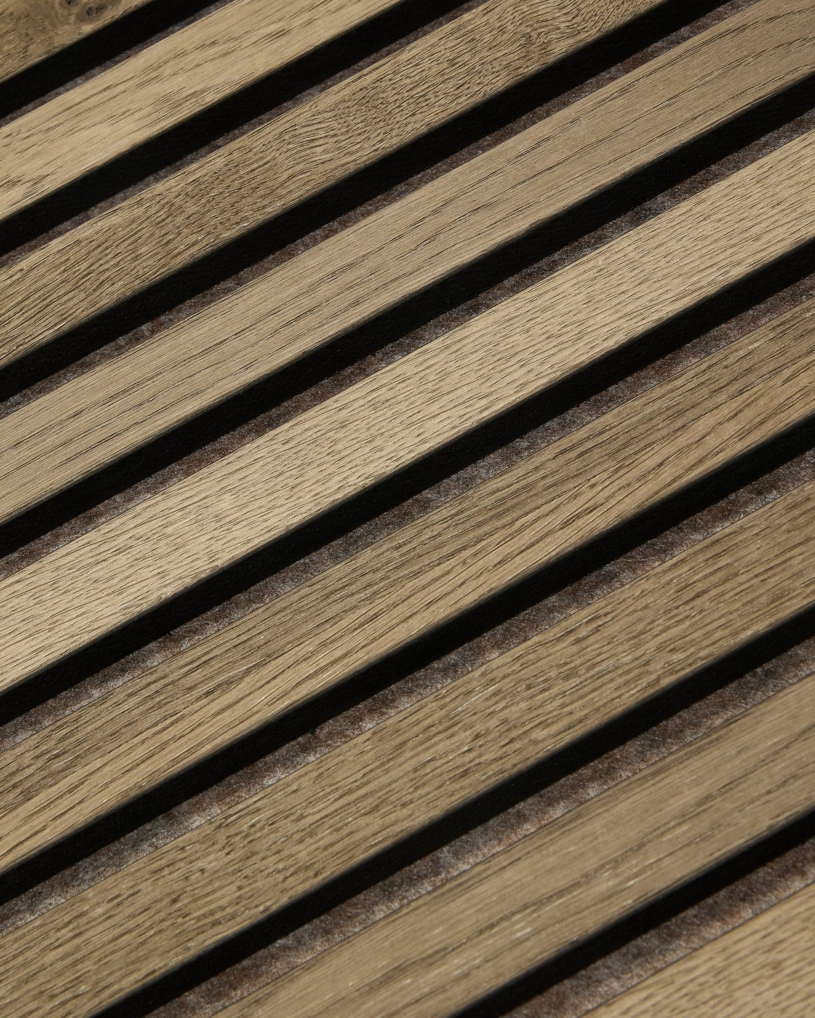 Close-up of WoodUpp Tonal Akupanel acoustic panel in Grey Oak (240x60 cm) showing evenly spaced diagonal slats with natural oak grain and Nordic design.
