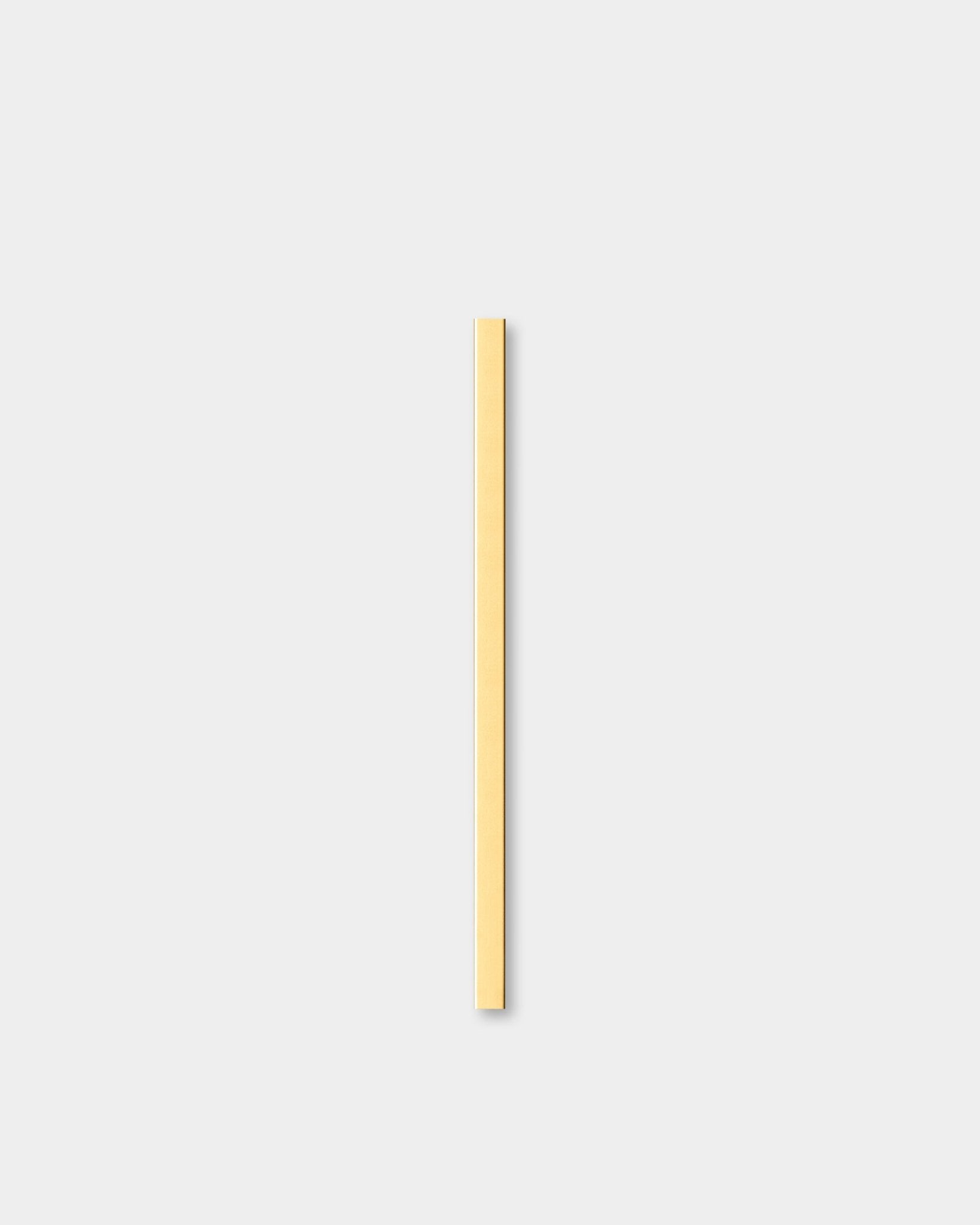 The Liva | Cover in brass, 60 cm by WoodUpp, an acoustic panel, stands vertically against a light gray background next to decorative wall trim.