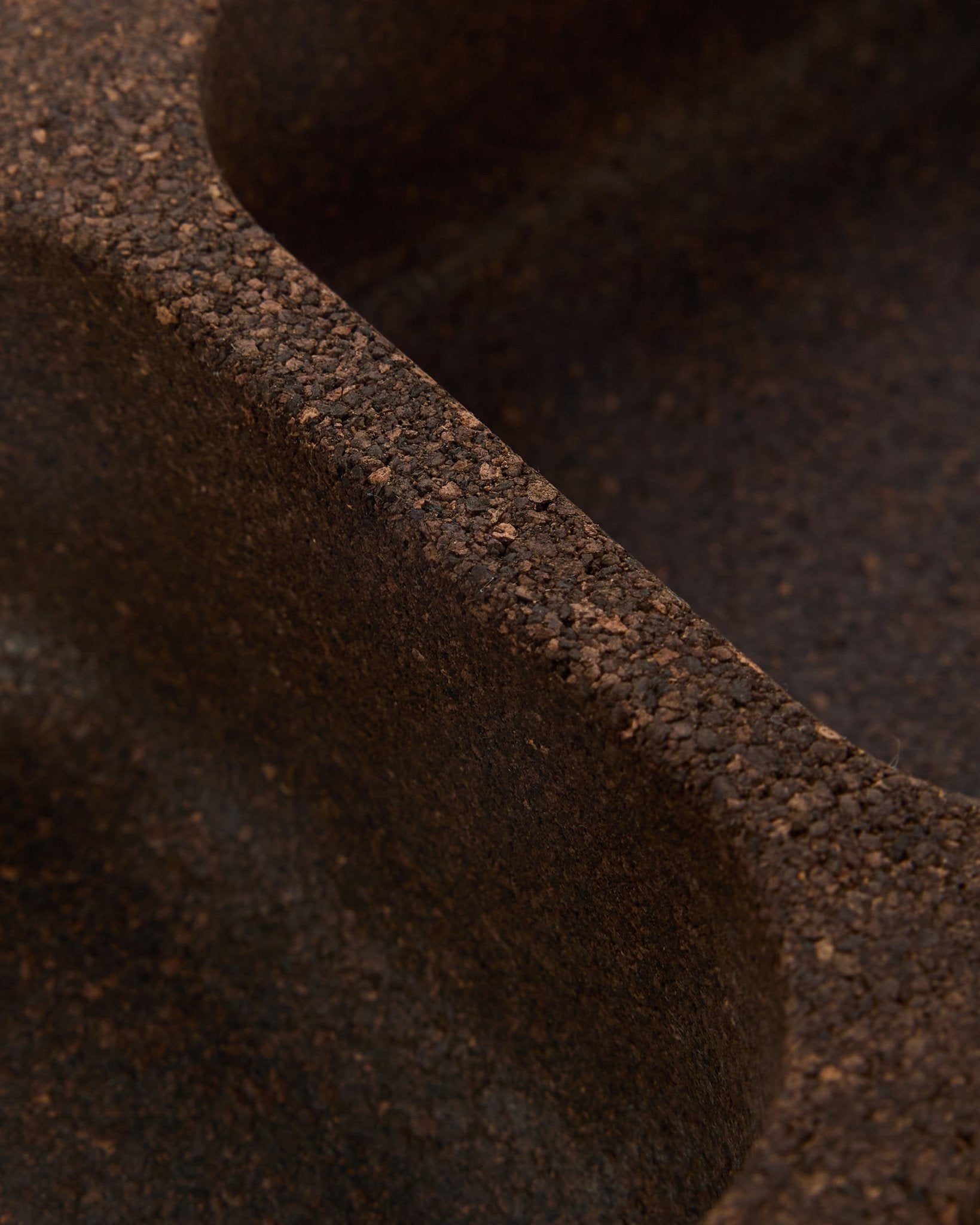 Close-up of WoodUpp Norr Key Tray accessory in smoked cork (35.9 cm), showing a textured brown surface with smooth, curved ridges and Nordic design.