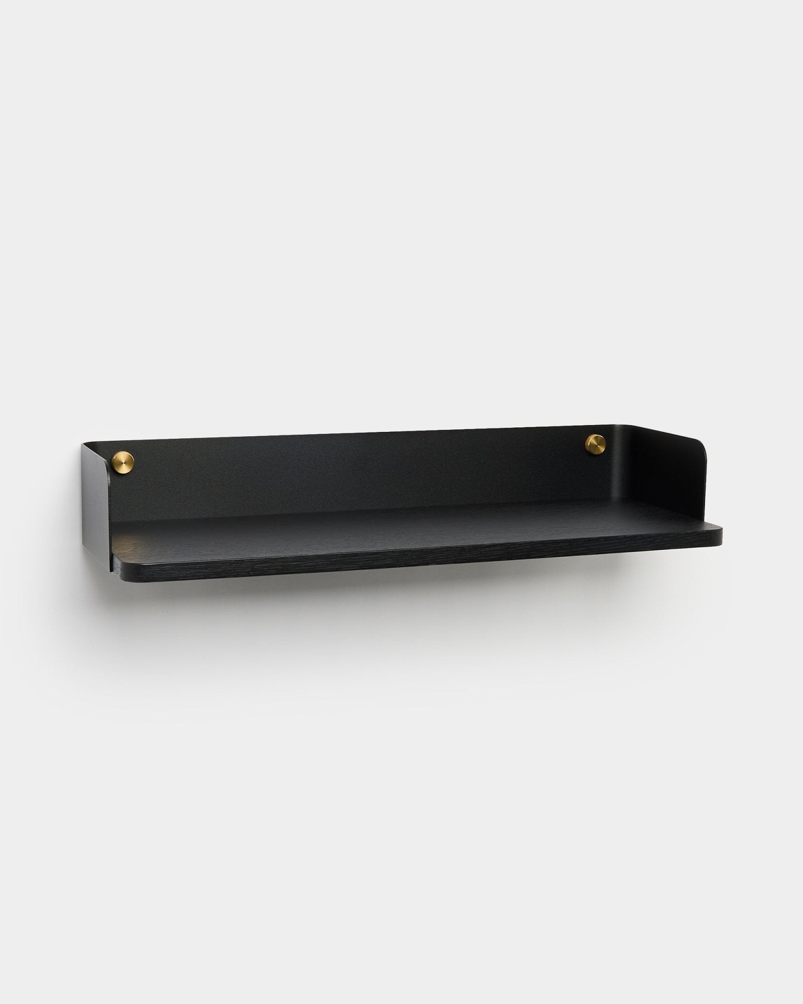 The Linn bookshelf by WoodUpp, a Danish brand, features black metal with raised sides and gold screws, designed for modern storage solutions.