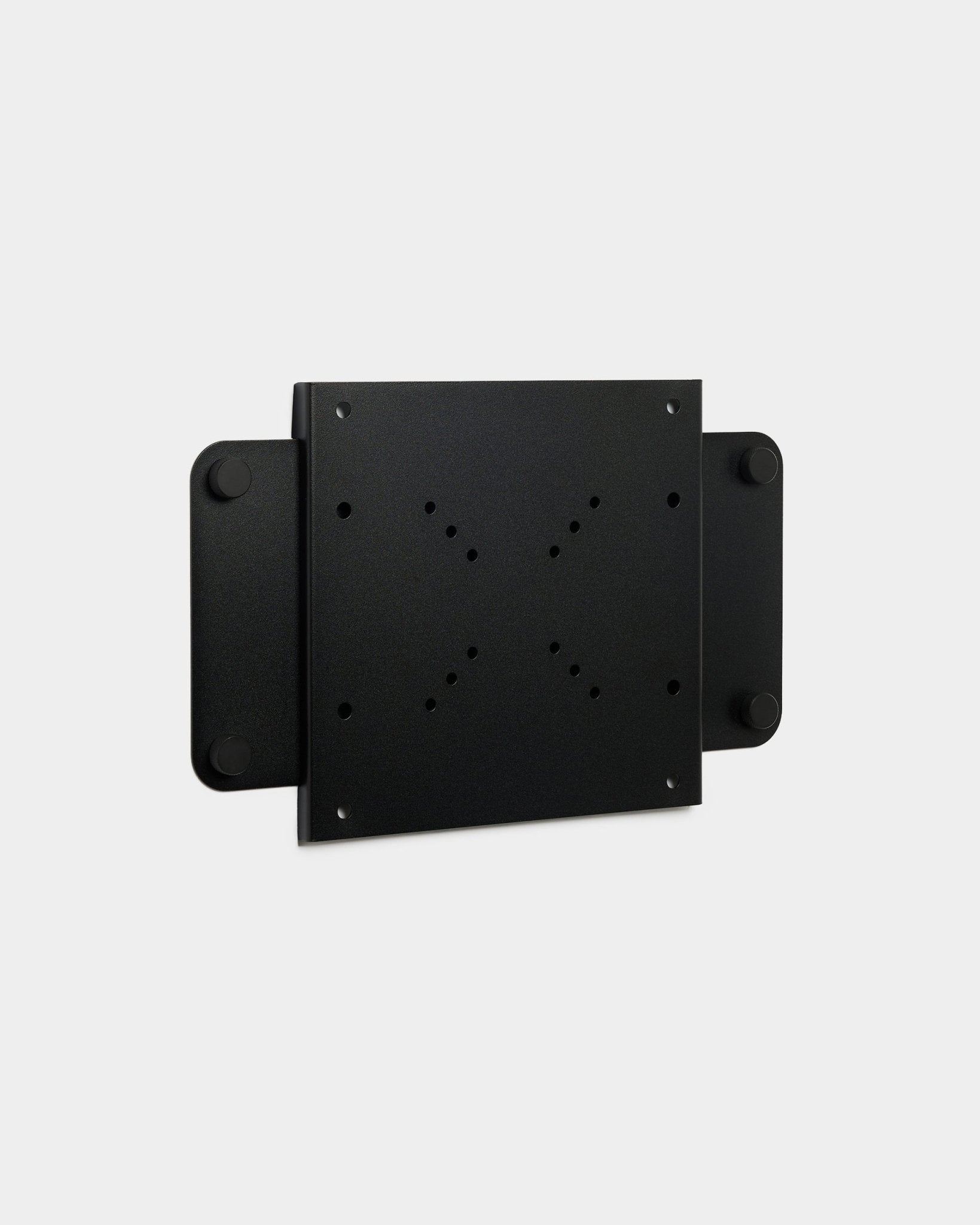 The Fjell | TV Mount (small) by WoodUpp, a black metal bracket with multiple screw holes and a magnetic lock, displayed on a white background.