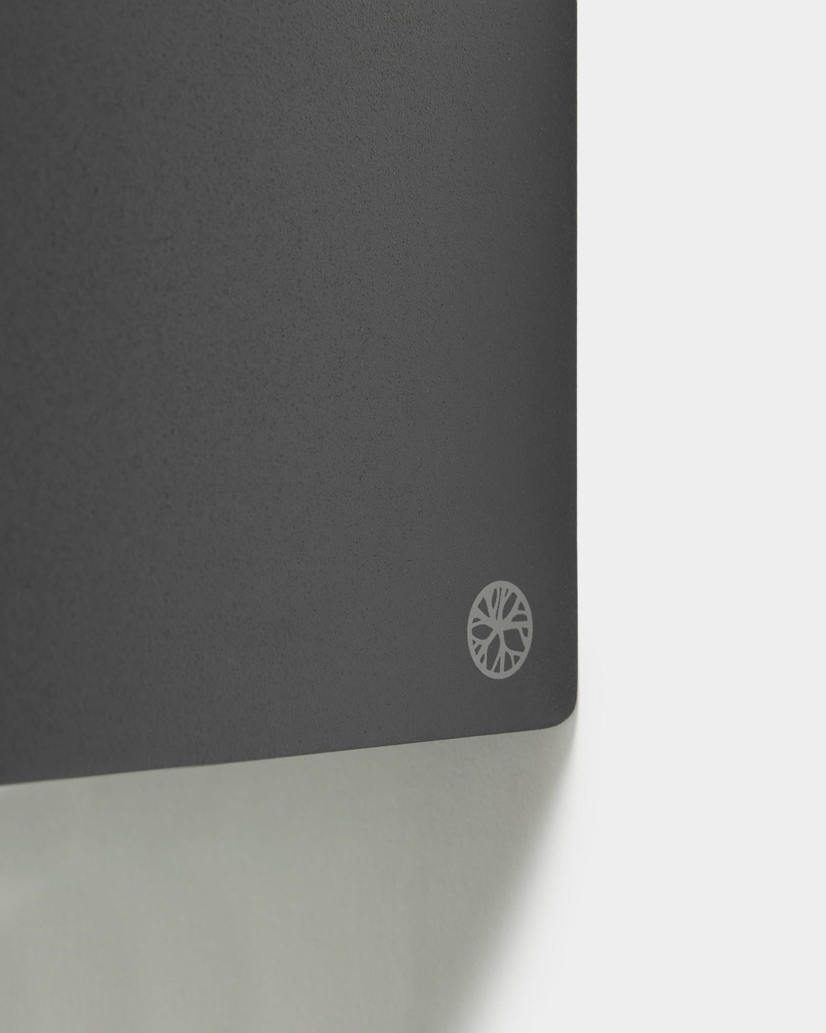 Close-up of the Norr Plant Box, 11.9 cm, in black by WoodUpp. White sunburst logo on the corner; light background. Nordic accessory for Akupanel series.