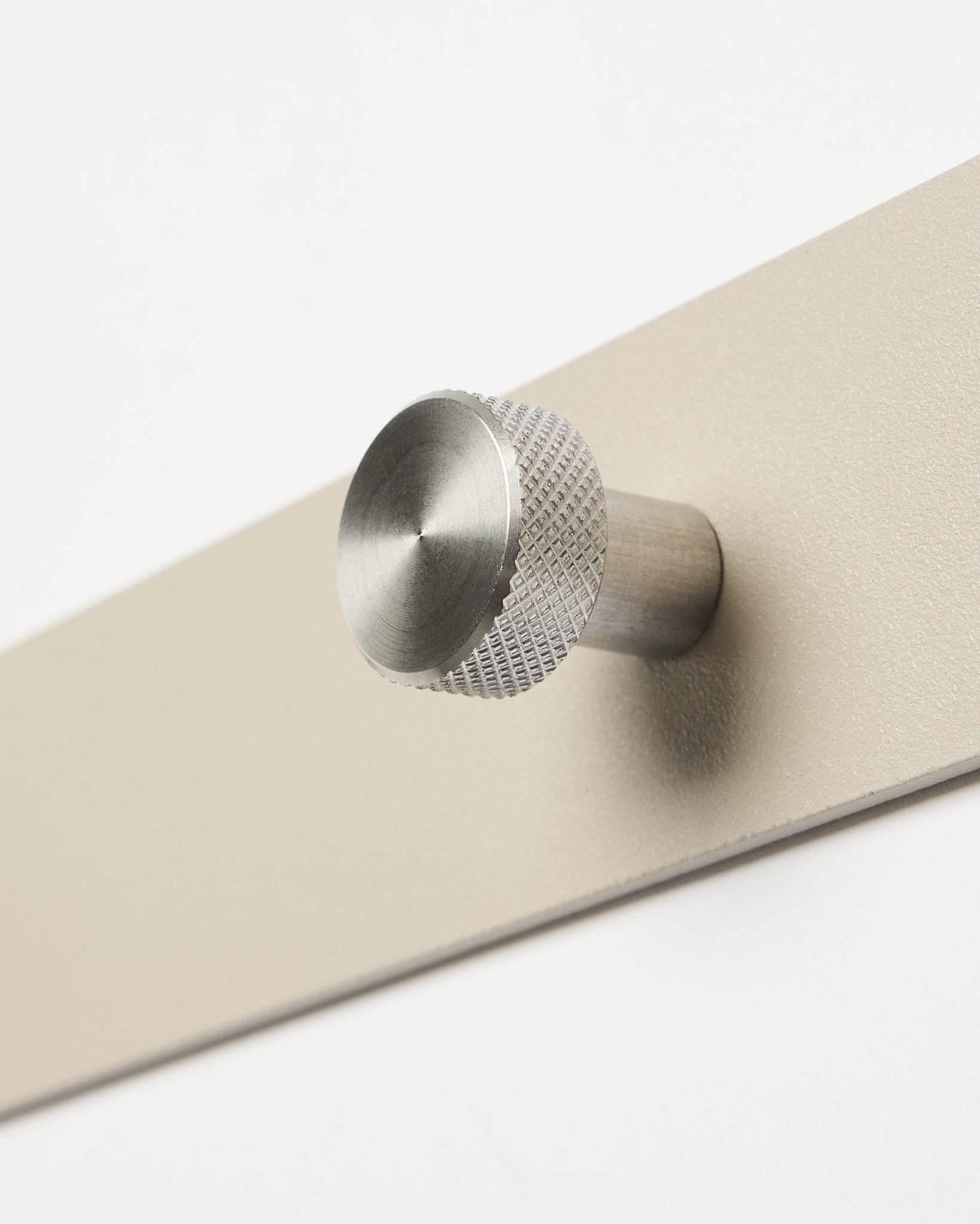 Norr Coat Hook Rack in beige and stainless steel by WoodUpp, accessory for Akupanel collection, shown close-up against a white background.