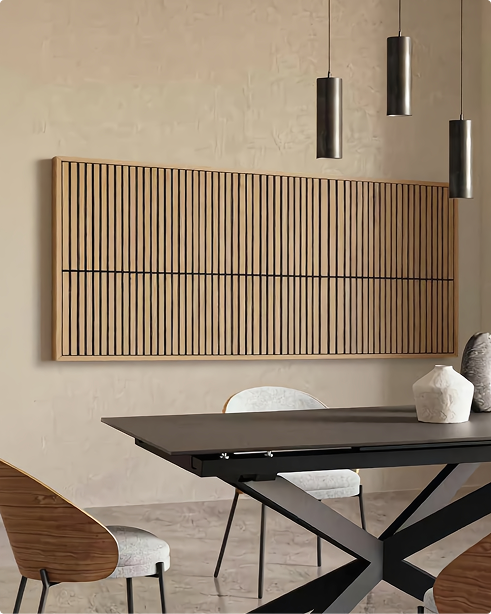 Modern dining area featuring a dark rectangular table, cushioned chairs, pendant lights, and a Nordic-style Akupanel acoustic wood slat wall panel.