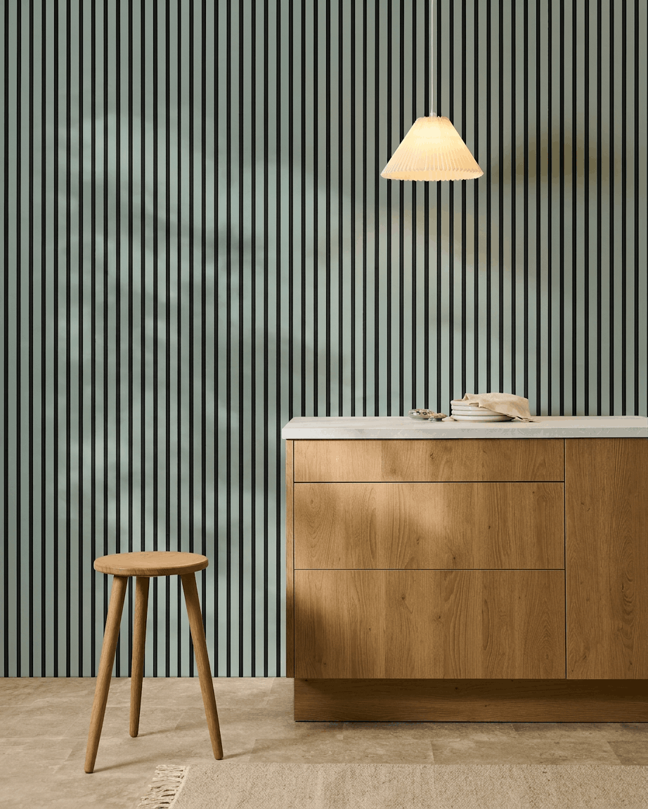 Minimalist Nordic kitchen featuring a wood stool, cabinet, and WoodUpp Akupanel acoustic panel in Cloud color with black felt (240x60cm) for acoustic comfort.