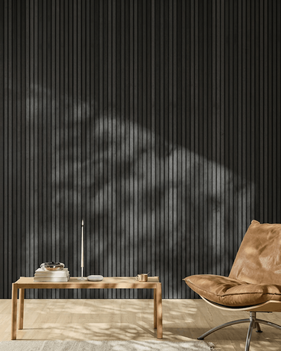 Minimalist interior featuring a brown leather chair, coffee table, and a WoodUpp Akupanel acoustic panel in Natural Wood/Black Ash, 300x60cm.