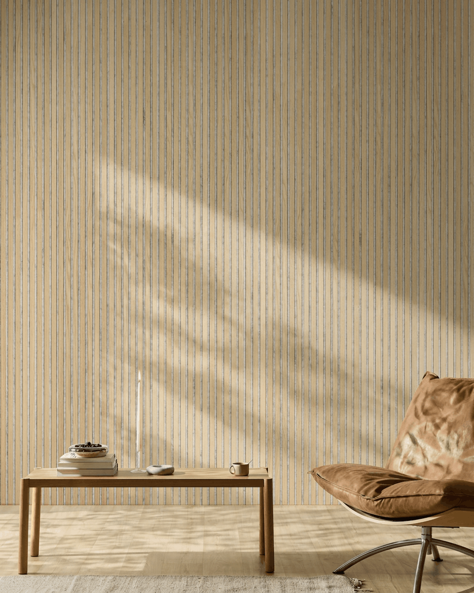 Minimalist room featuring a tan leather chair, wood table, and candle. WoodUpp Akupanel Classic Oak acoustic slatwall panel adds Nordic style and sound comfort.